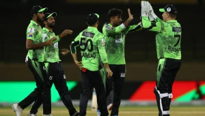 Lahore Qalandars players celebrating a wicket with high-fives during a PSL cricket match in green team kits