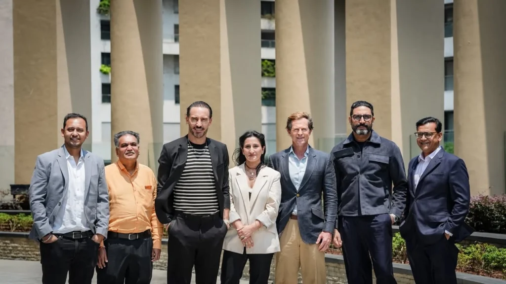 Madhukar Shree, Samir Shah, Faf du Plessis, Priyanka Kaul, Jonty Rhodes, Abhishek Bachchan and Saurav Banerjee posing together outdoors representing Team Rotterdam and RulesX
