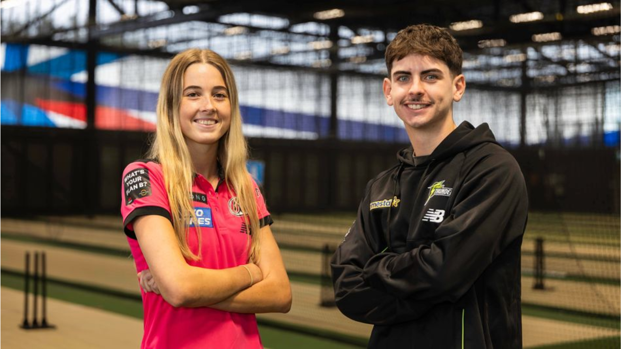 NSW College of Sport athletes pose inside indoor cricket training facility with nets and practice pitches in background