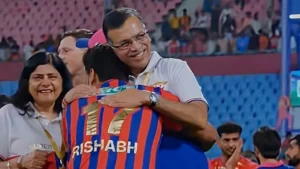 Sanjiv Goenka embraces Rishabh Pant on the field during an IPL match in a celebratory moment.
