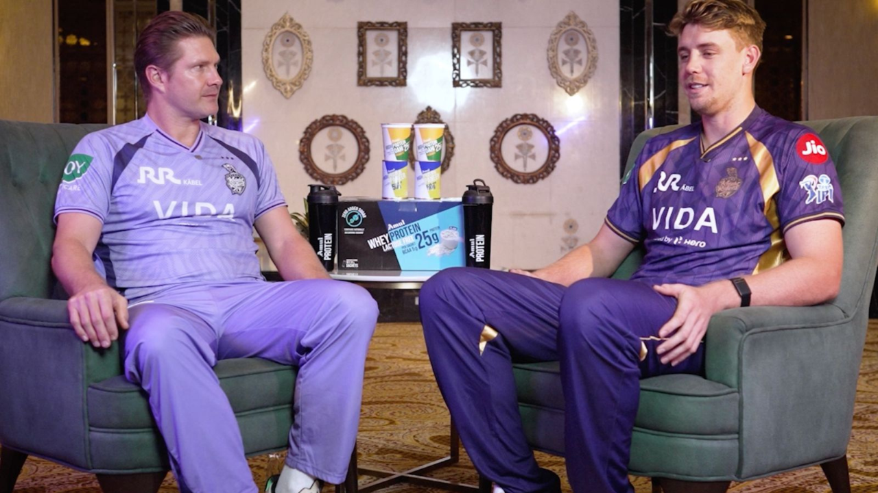 Shane Watson and Cameron Green in KKR jerseys during indoor interview session with protein products display