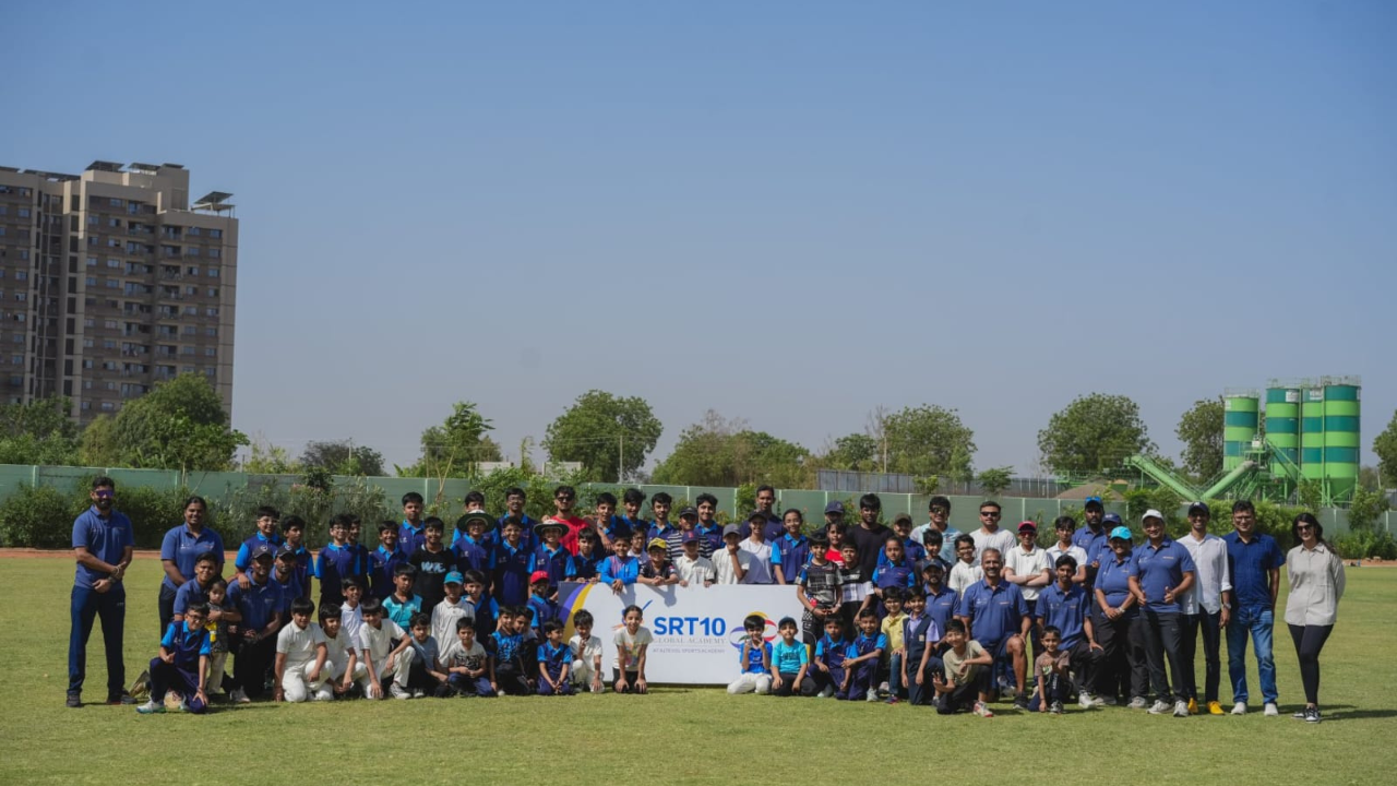 Large group of young cricketers and coaches posing on a cricket field at SRT10 Altevol Centre of Excellence Sports Academy event
