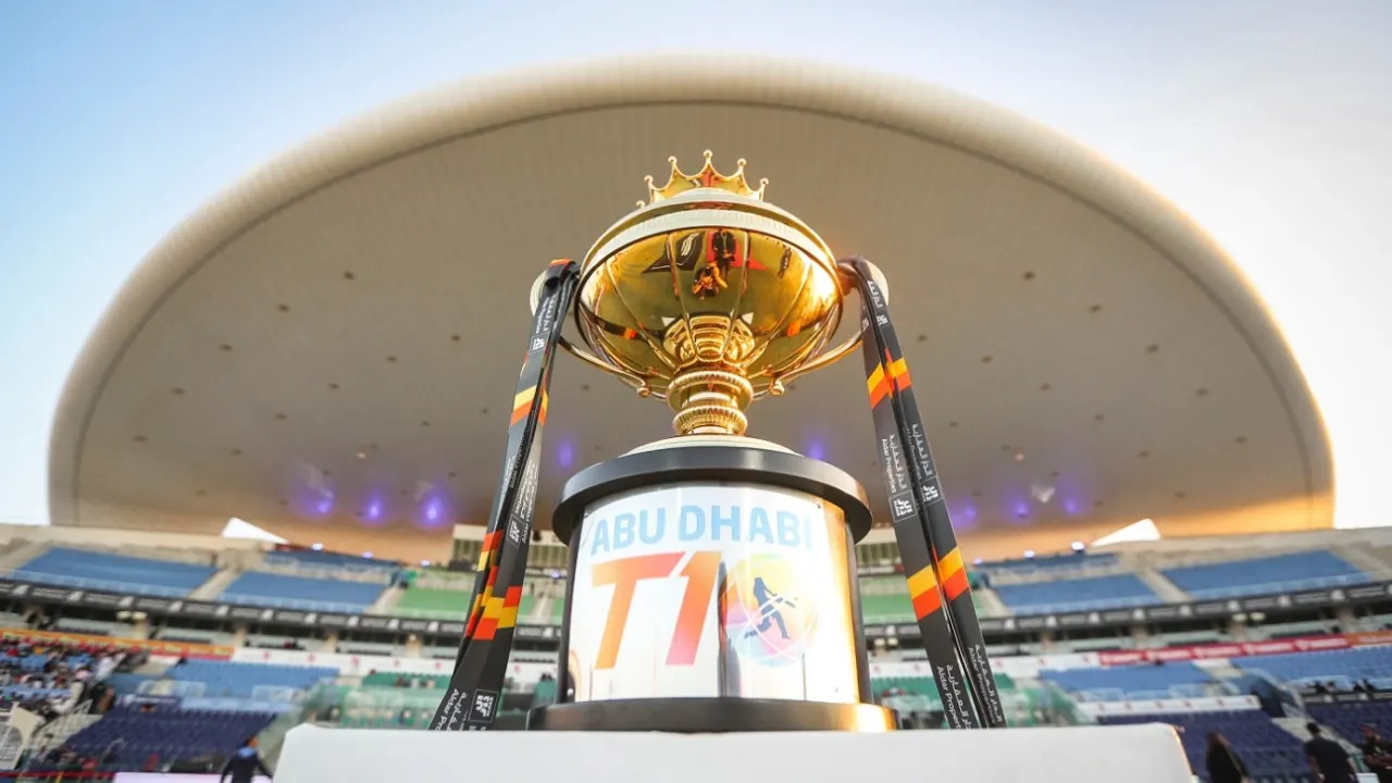 Gold Abu Dhabi T10 cricket tournament trophy displayed on a podium inside a stadium before the match event.