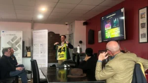Ben Hardy-Jones, Business Sustainability Lead at Desert Vipers, presenting a team jersey and addressing panel discussion delegates during a sustainability session at WA Cricket.