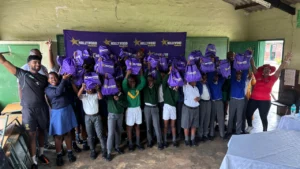 School children celebrate while receiving cricket equipment and backpacks during Cricket South Africa’s Ready to Play programme at a community school in South Africa.