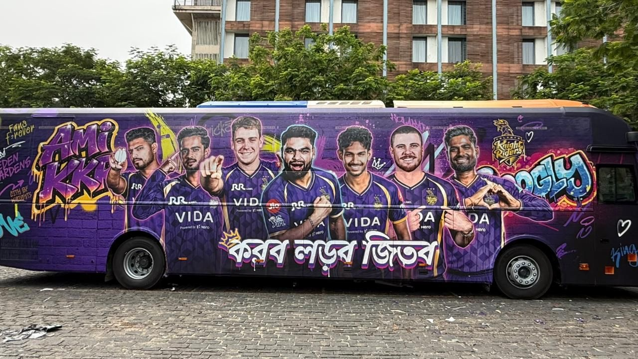 Kolkata Knight Riders team bus with graffiti-style artwork featuring multiple KKR players and branding during IPL season