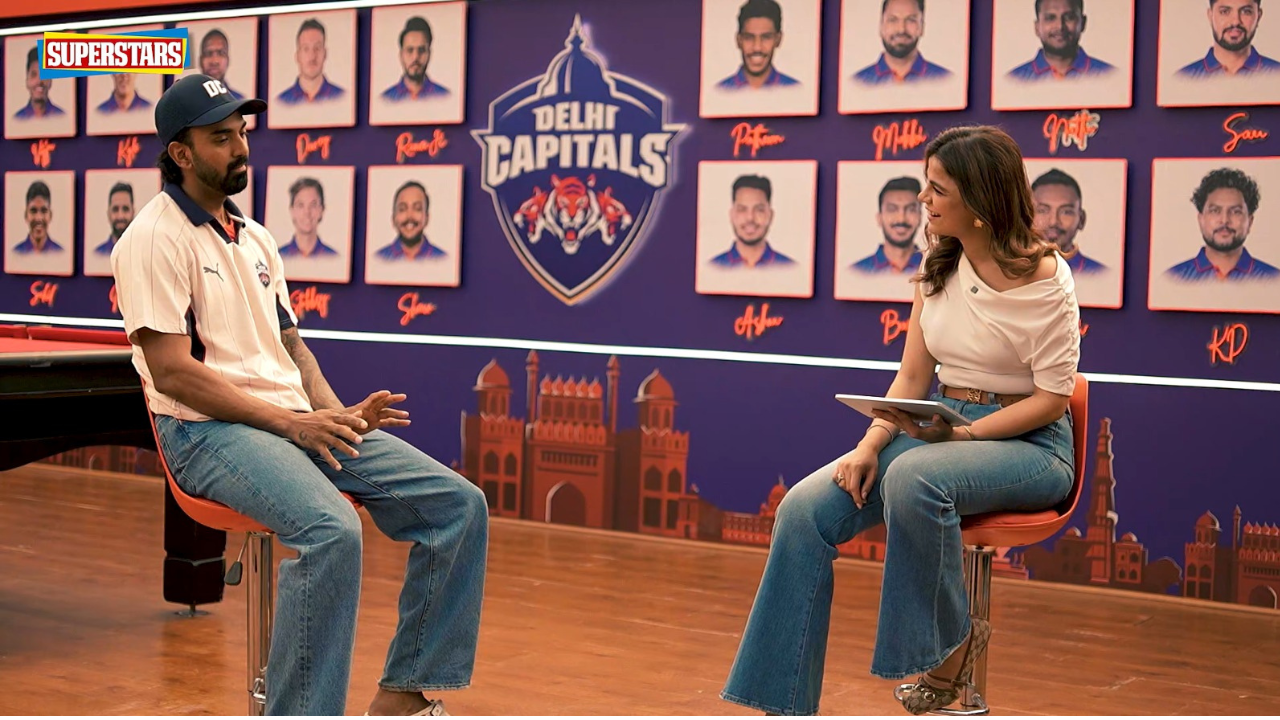 KL Rahul speaking during JioHotstar Superstars interview with host in front of Delhi Capitals team backdrop