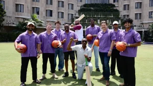 Kolkata Knight Riders players and support staff pose with NBA legends Isiah Thomas and DeMarcus Cousins during a meet-and-greet session.