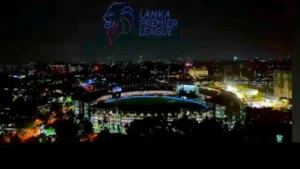 Aerial night view of a cricket stadium illuminated during the Lanka Premier League with city lights in the background in Sri Lanka.