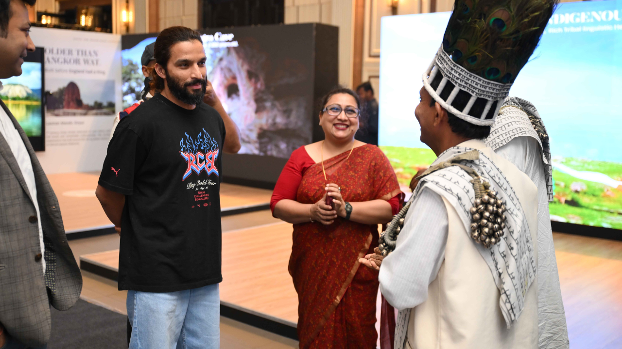 Rajat Patidar interacts with performers and attendees during a cultural tourism event in Raipur, India.