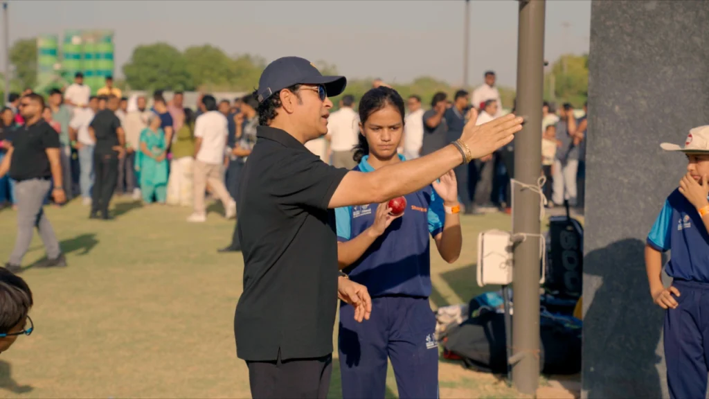 Sachin Tendulkar interacting with female cricketers during an SRT10 grassroots session at the Ahmedabad academy