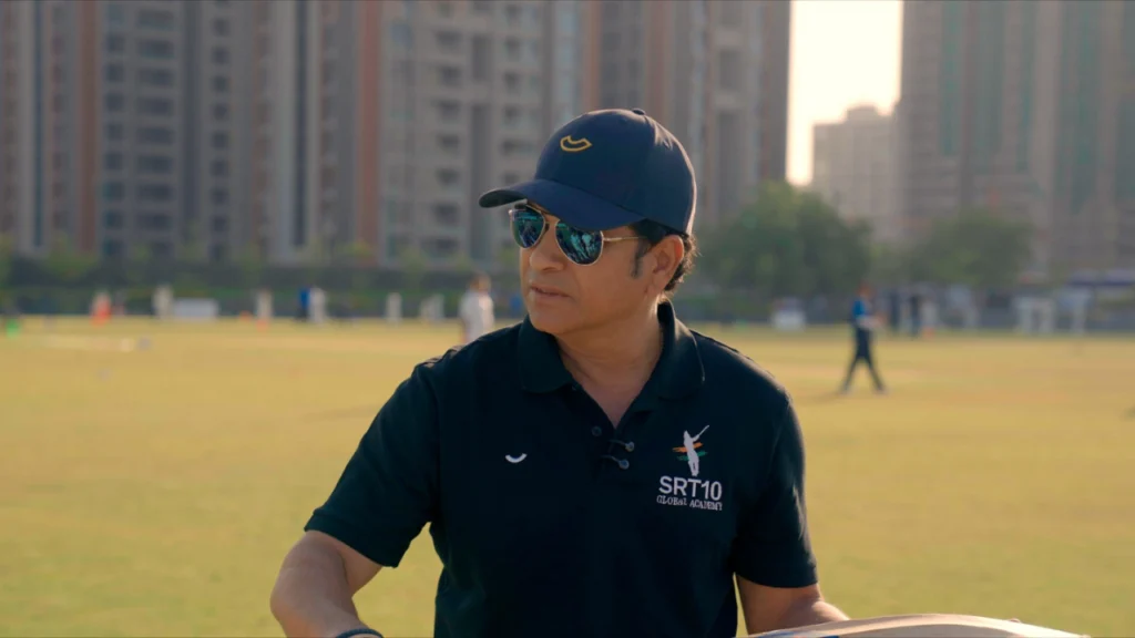 Sachin Tendulkar wearing an SRT10 Global Academy shirt during a grassroots cricket session in Ahmedabad