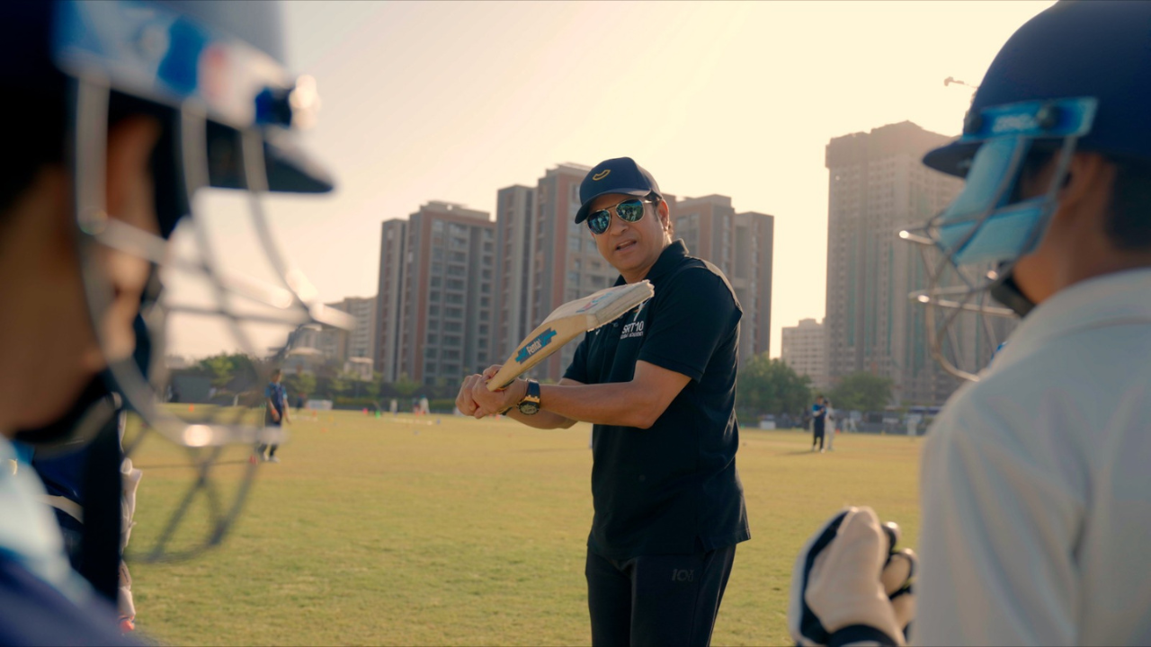 Sachin Tendulkar coaching young cricketers during an SRT10 grassroots cricket session at an academy in Ahmedabad
