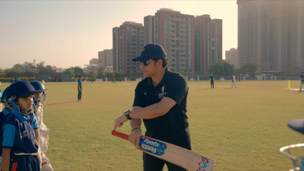 Sachin Tendulkar coaching young cricketers with batting guidance during an SRT10 session at the Ahmedabad academy