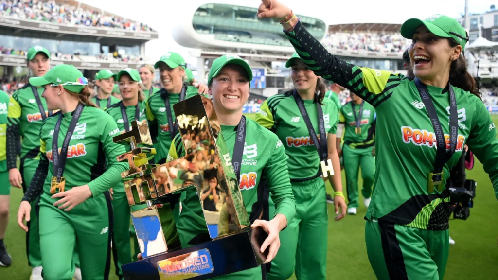 Southern Brave women’s team celebrating with The Hundred trophy at Lord’s Cricket Ground after winning the title.