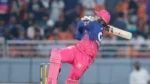 Vaibhav Sooryavanshi of Rajasthan Royals plays an attacking shot during an IPL match, showcasing his batting talent in front of a packed crowd.