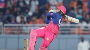 Vaibhav Sooryavanshi of Rajasthan Royals plays an attacking shot during an IPL match, showcasing his batting talent in front of a packed crowd.