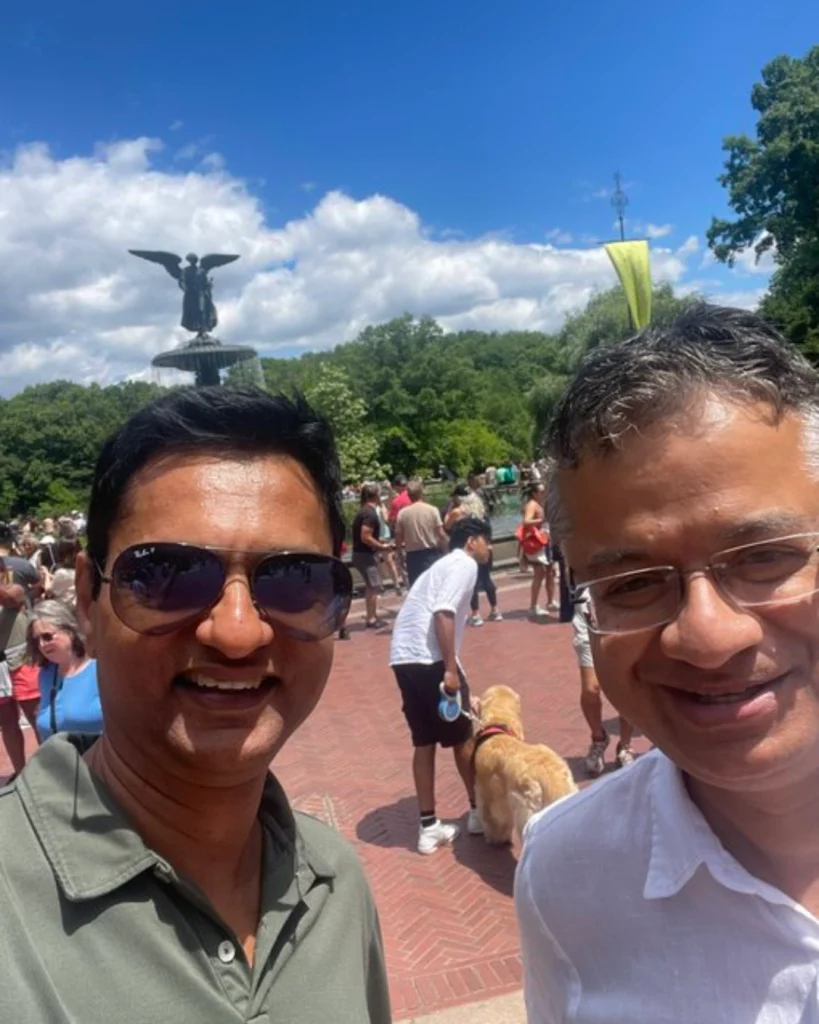 Anand Rajaraman and Vishal Misra pose for a photo at Central Park in New York City with Bethesda Fountain in the background.