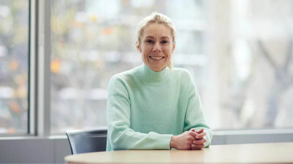 Beth Barrett-Wild, Director of Women's Professional Game at the ECB, seated at a table in a professional office setting.