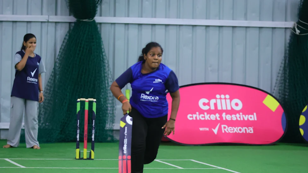 Participant batting during the Criio Cricket Festival with Rexona, taking part in a community women's cricket activity on an indoor practice pitch.