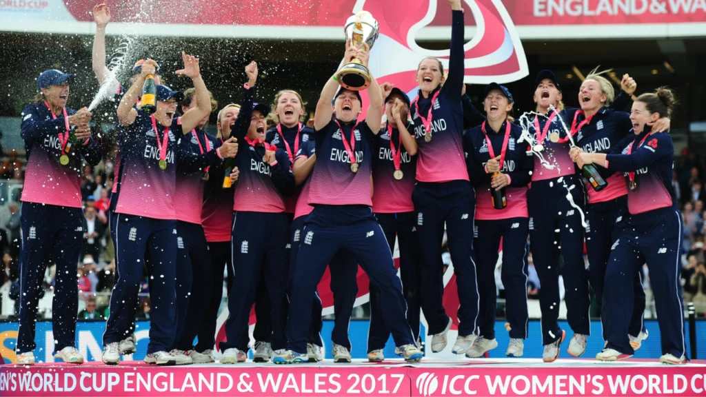England women's cricket team celebrating with the ICC Women's Cricket World Cup trophy after winning the 2017 tournament in England and Wales.