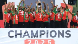 Guyana Amazon Warriors players celebrate with the trophy after winning the 2025 Guyana Global Super League title, posing on stage during the championship presentation.