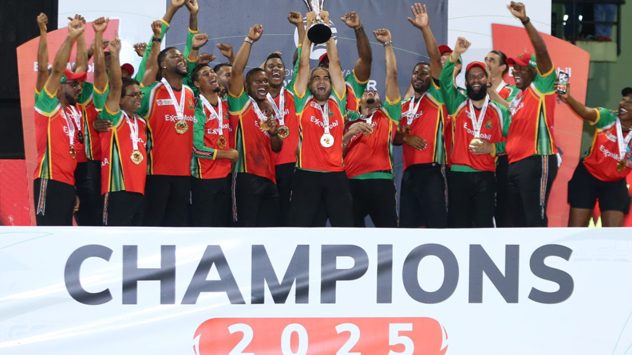 Guyana Amazon Warriors players celebrate with the trophy after winning the 2025 Guyana Global Super League title, posing on stage during the championship presentation.