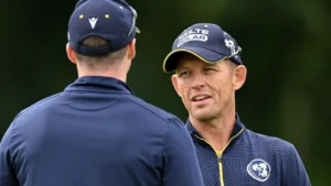 Heinrich Malan, Ireland men's cricket head coach, speaks with a player during a training session ahead of an international match.
