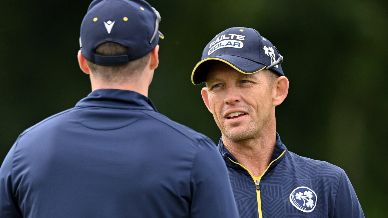 Heinrich Malan, Ireland men's cricket head coach, speaks with a player during a training session ahead of an international match.