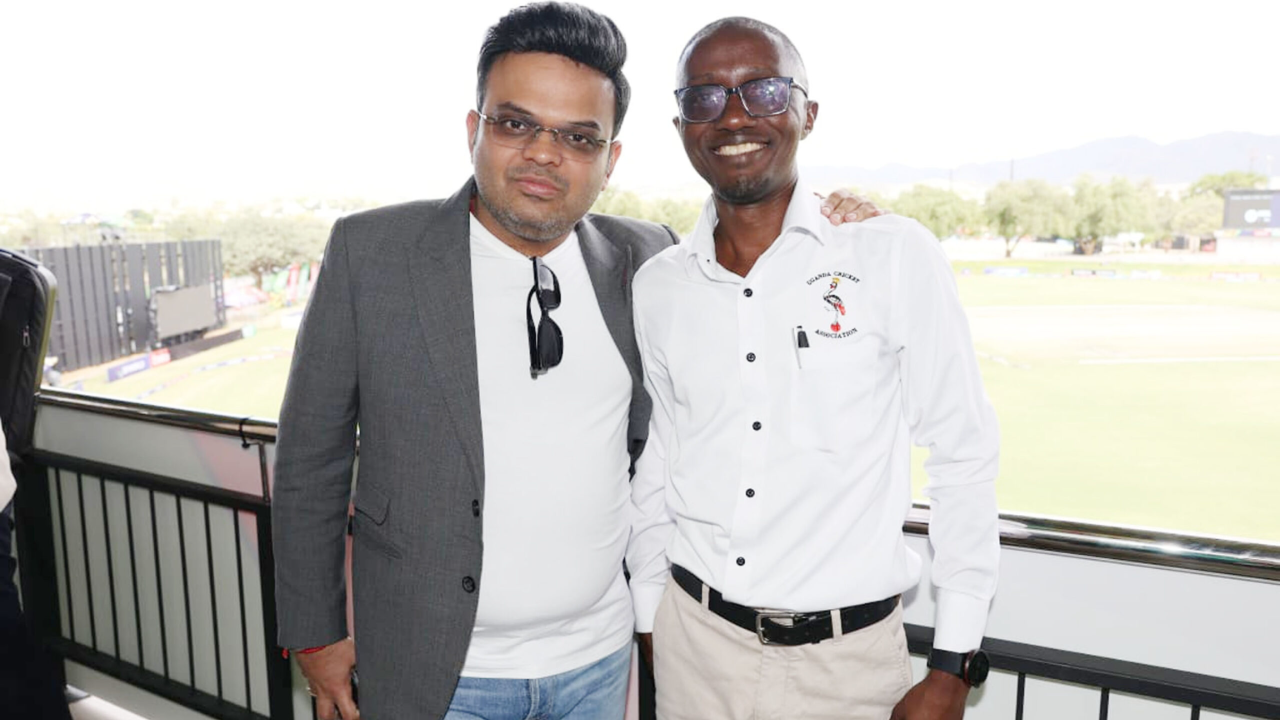 ICC Chairman Jay Shah and Uganda Cricket Association Chairman Jackson Kavuma pose together at a cricket venue during an official cricket administration event.