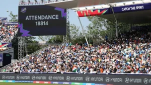 Large crowd of cricket fans filling the stadium stands during the ICC Women’s T20 World Cup, with a giant screen displaying attendance of 18,814 spectators.
