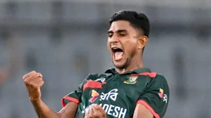 Nahid Rana celebrates a wicket during a Bangladesh cricket match, raising his fists and shouting in celebration on the field.