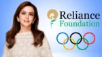 Nita Ambani pictured alongside the Reliance Foundation logo and Olympic rings, highlighting her role in promoting sports development and Olympic initiatives in India.