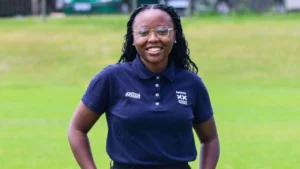 Sobahle Mabuza poses for a portrait on a cricket field, wearing an official cricket administration polo shirt.