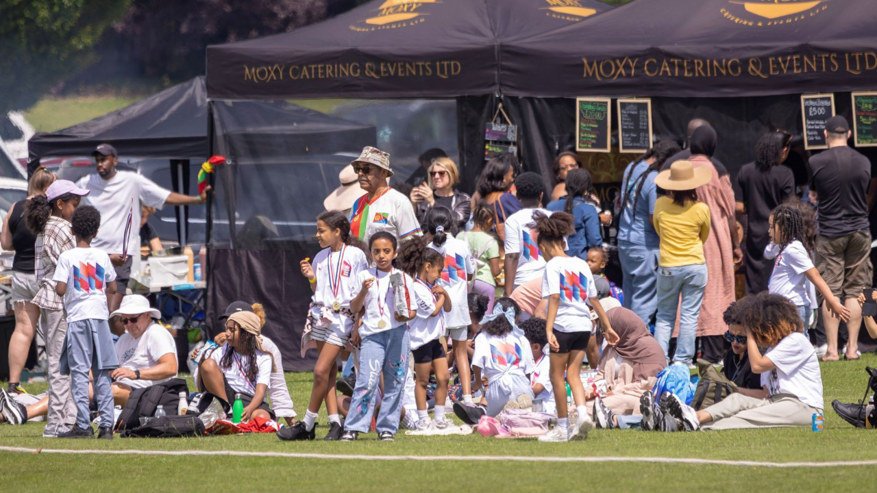 Children and families gather at a community cricket event supported by the ECB and Castore cricket kit donation programme, promoting grassroots participation and access to cricket equipment.