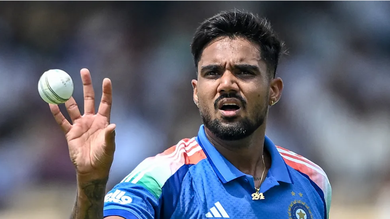 India fast bowler Gurnoor Brar holds a cricket ball during a match, preparing to bowl while wearing the Indian cricket team jersey.