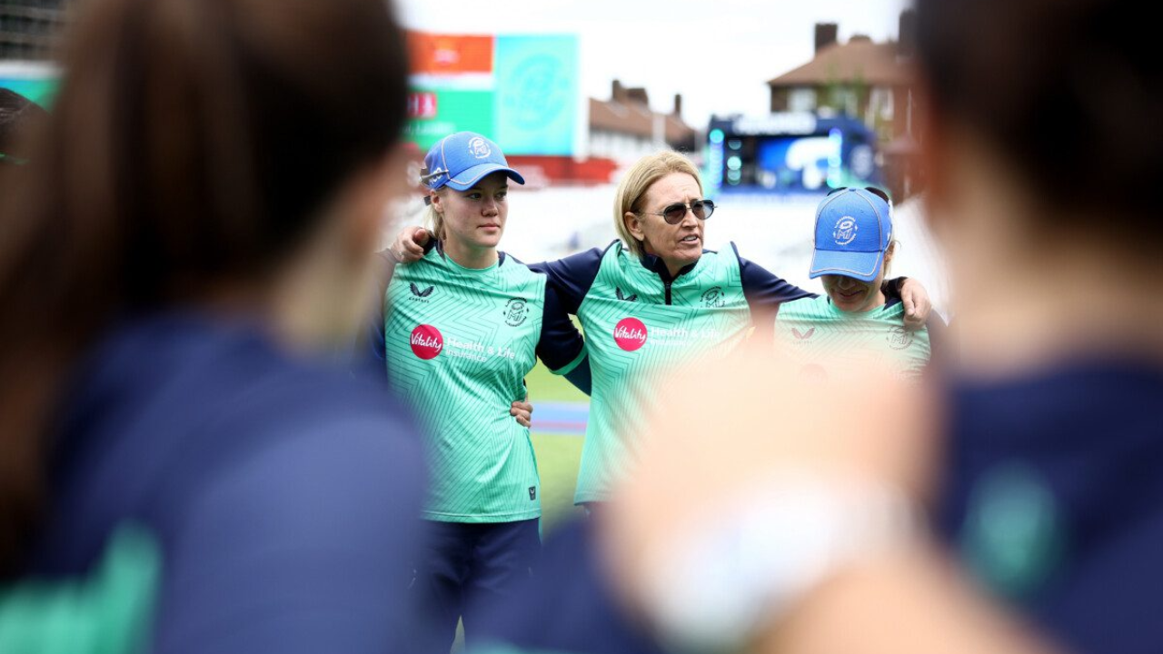 Lisa Keightley speaks to MI London players during a training session in her role as batting coach, delivering instructions ahead of a cricket match.