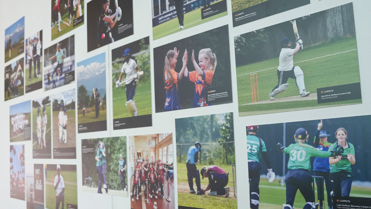 Display wall at Lord's Cricket Ground featuring photographs from the Lord's Cricket For Good photography exhibition, showcasing grassroots cricket, youth participation, women's cricket, and community cricket initiatives.