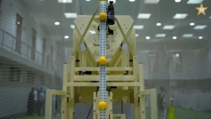 Automated bowling machine installed at the National Cricket Academy indoor training facility for player practice and skill development.