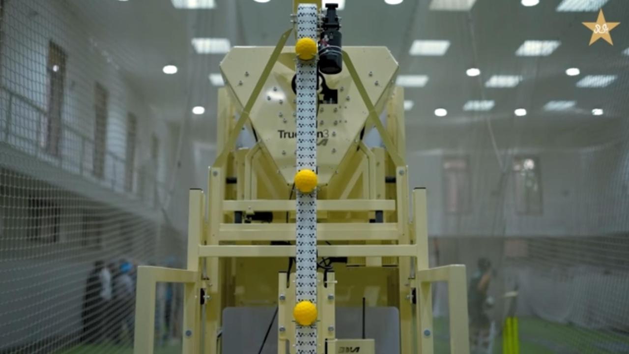 Automated bowling machine installed at the National Cricket Academy indoor training facility for player practice and skill development.