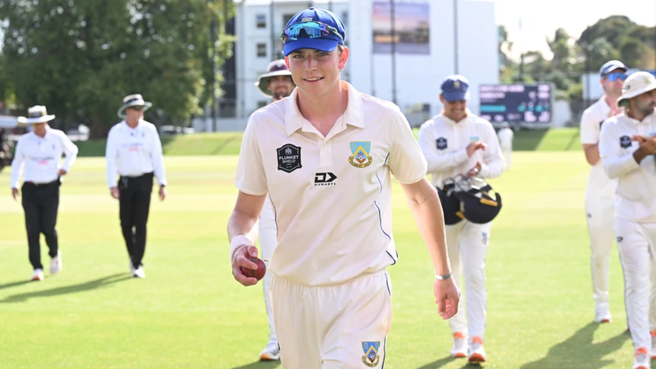 New Zealand domestic cricketer walks off the field holding the match ball after a Plunket Shield cricket match.