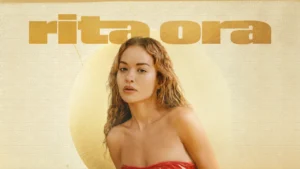Promotional portrait of singer Rita Ora featured on artwork with her name displayed prominently in the background.