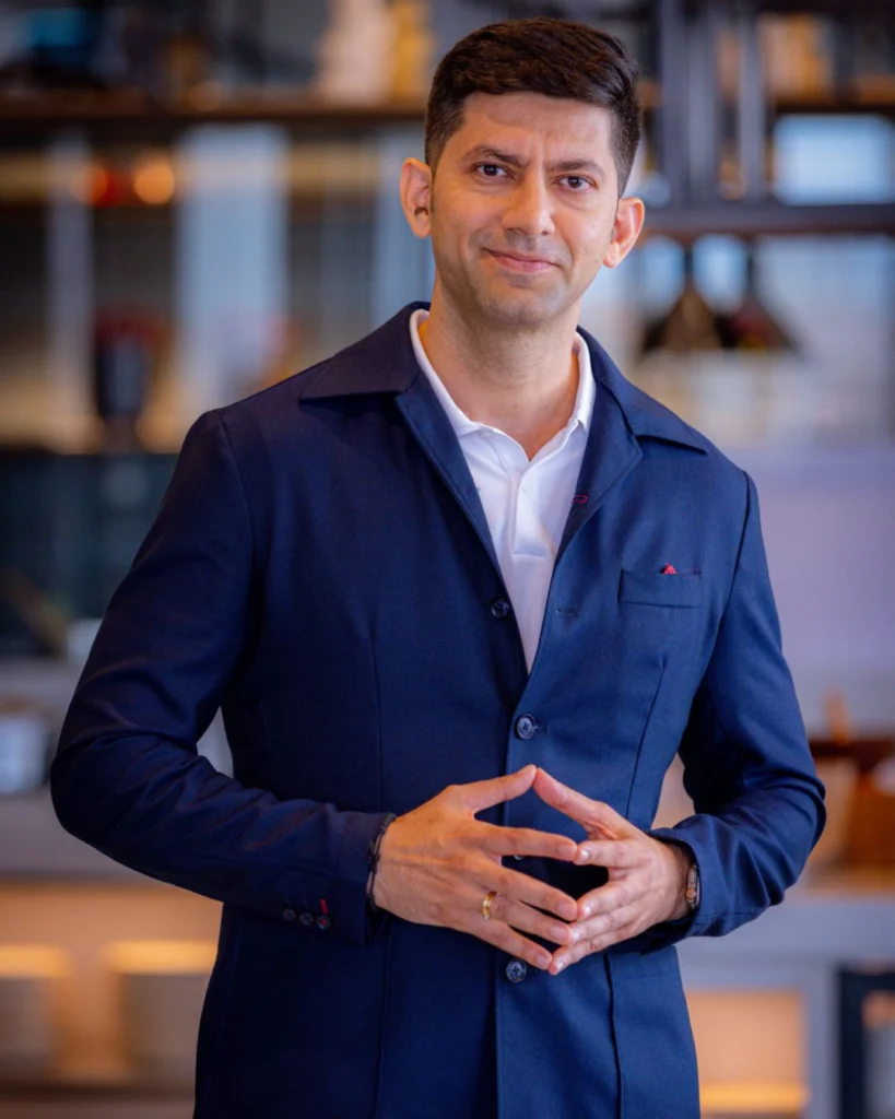 Portrait of Satyam Trivedi, founder of PlayBlue, posing in a business setting.