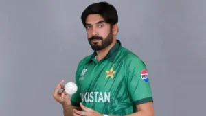 Pakistan cricketer Usman Tariq poses in the national team jersey while holding a cricket ball during an official portrait session.