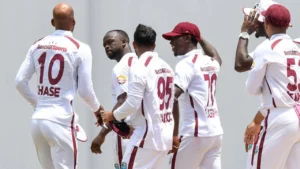 West Indies cricket players celebrate after taking a wicket during an international cricket match.
