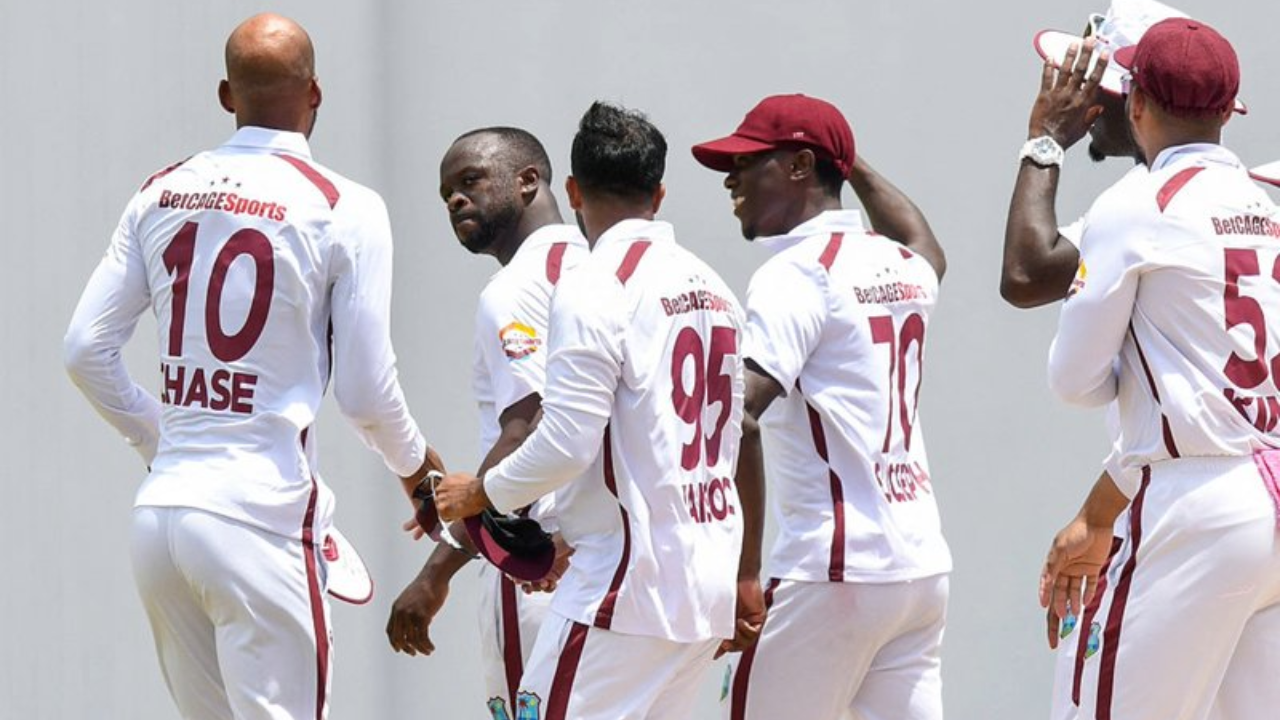 West Indies cricket players celebrate after taking a wicket during an international cricket match.