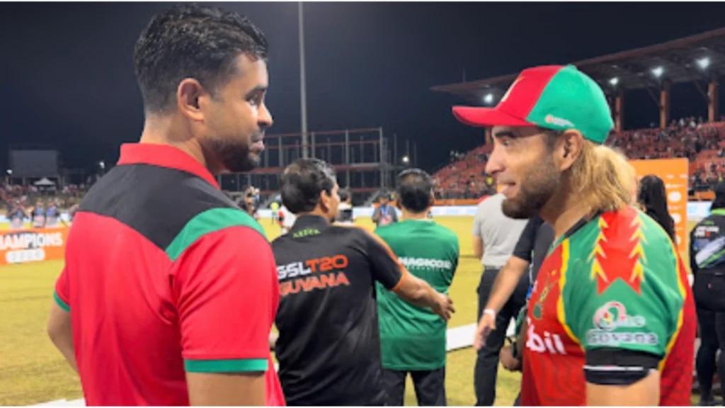 Guyana Minister of Culture, Youth and Sport Charles Ramson Jr congratulates Guyana Amazon Warriors captain Imran Tahir after the CPL final at the stadium.