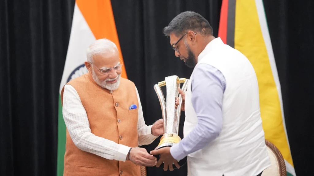 Indian Prime Minister Narendra Modi receives the ExxonMobil Guyana Global Super League (GSL) trophy from Guyana President Dr. Mohamed Irfaan Ali during an official meeting.