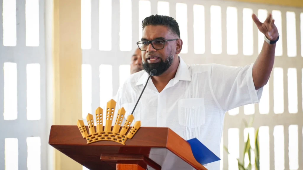 Guyana President Dr. Irfaan Ali delivers a speech at a podium. Ali has served as President since 2020 and conceived the vision for the Guyana Global Super League.