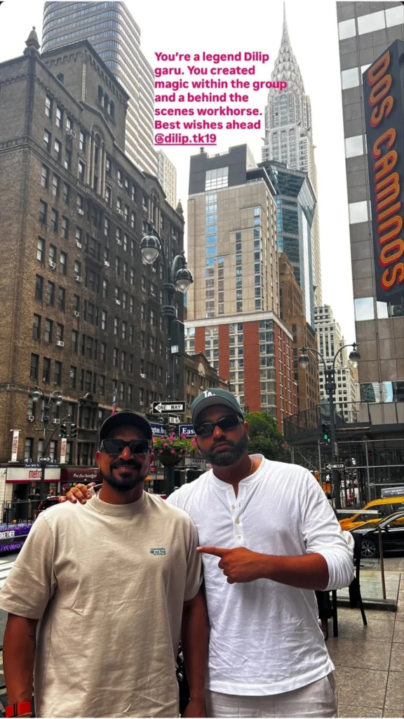 Indian cricket captain Rohit Sharma poses with T. Dilip in New York City with the Chrysler Building in the background.